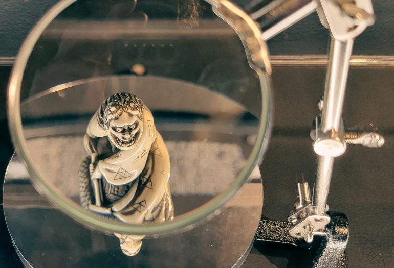 Photo: A netsuke carving at the Portland Japanese Garden is on display under a small magnifying glass, bringing to life the fine details of the piece.