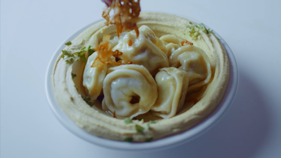 Hummus Topped With Varenikis And Fried Onions