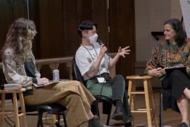 Three people sit speaking with microphones at the Portland Book Festival.
